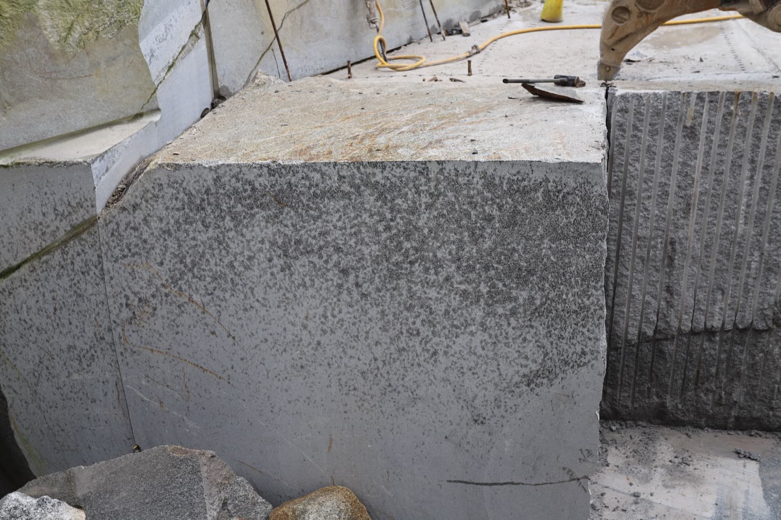 Freshly quarried De Lank silver-grey granite blocks on the quarry floor, Cornwall