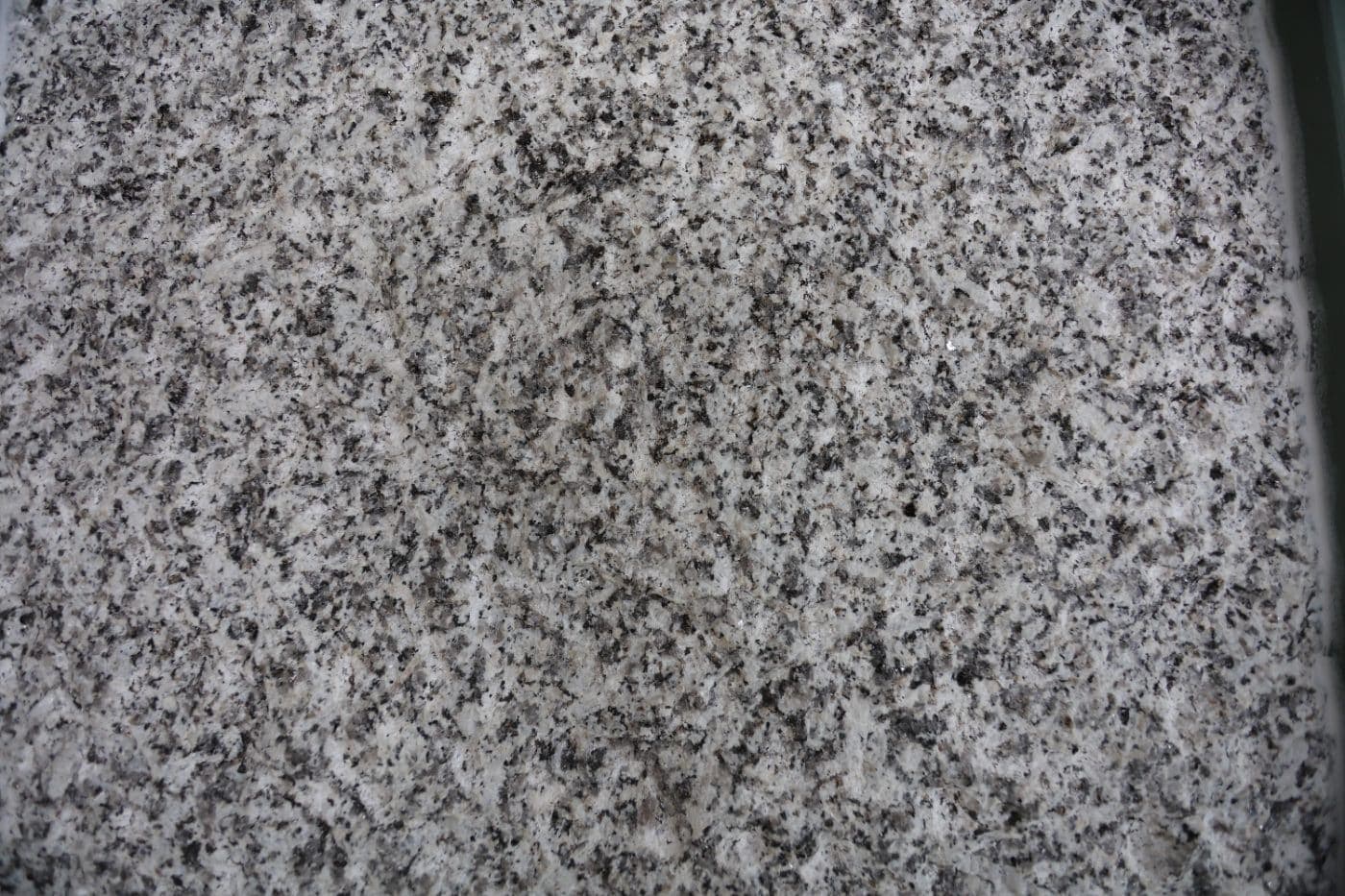 De Lank Cornish granite hand punched finish — A bold, deeply textured finish created by heavy punch tools. More robust than do