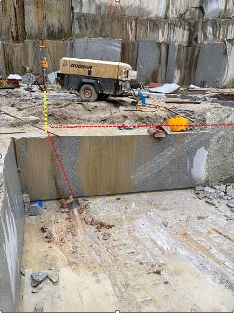 The line of the vertical bore from the top of the bench and the horizontal bore from the face, marked up on the working bench before drilling
